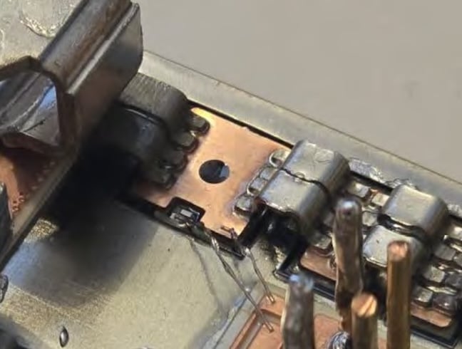 Close-up view of the tab-and-clip interconnection technology, whichreplaces bond wires in this design.